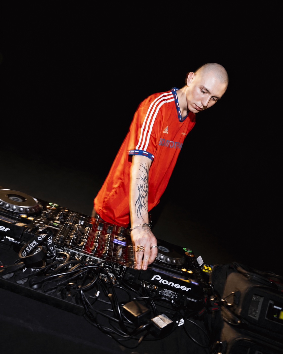 NOKIANGEL performing at Pioneer DJ equipment in a red shirt